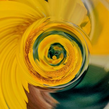 Abstract swirl of yellow and green hues, resembling a floral pattern.